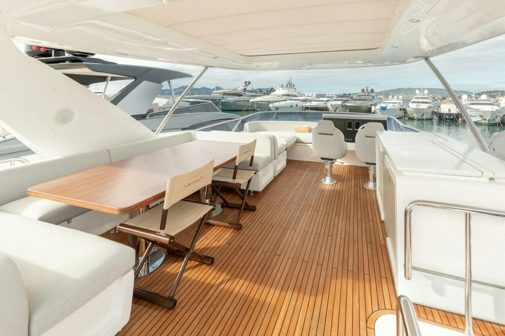 a room with a deck and chairs aboard SOLSTICE Yacht for Sale