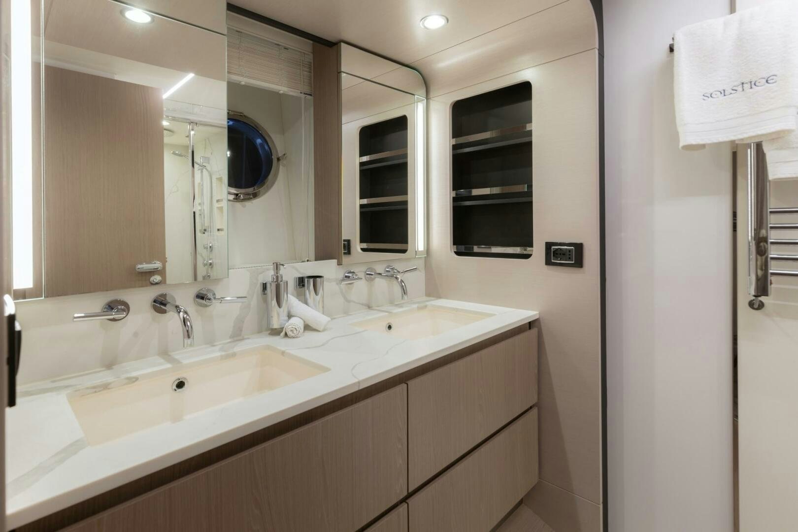 a bathroom with sinks and mirrors aboard SOLSTICE Yacht for Sale
