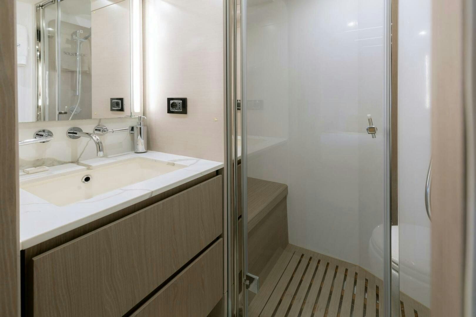 a bathroom with a glass shower aboard SOLSTICE Yacht for Sale