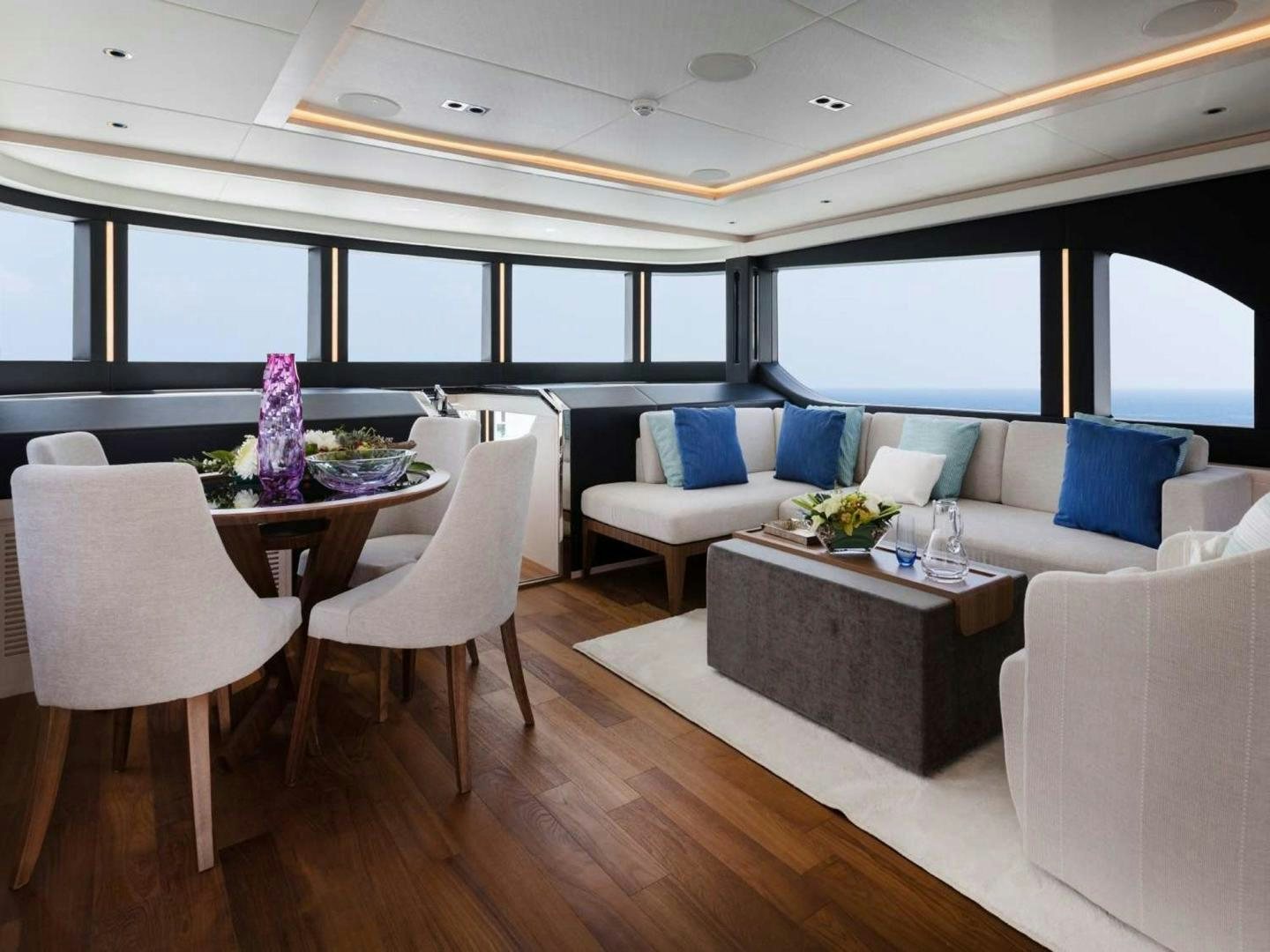 a room with a table and chairs aboard OCEAN VIEW Yacht for Sale