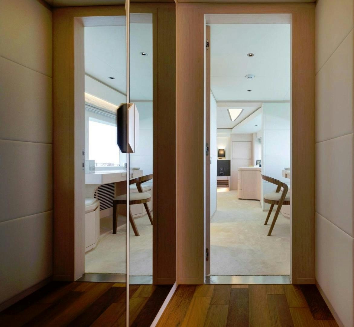 a hallway with a door and a table aboard OCEAN VIEW Yacht for Sale