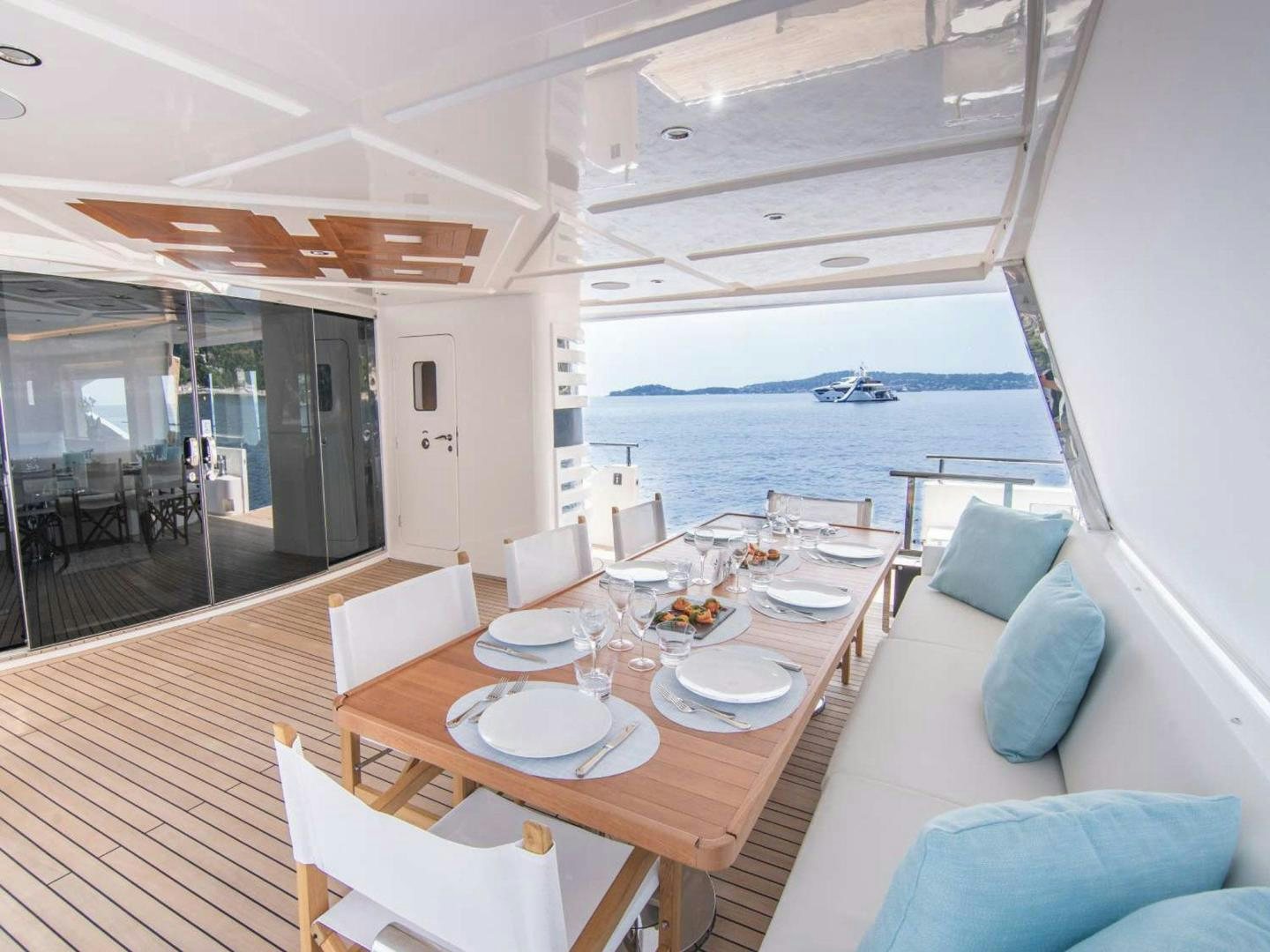 a room with a table and chairs aboard OCEAN VIEW Yacht for Sale