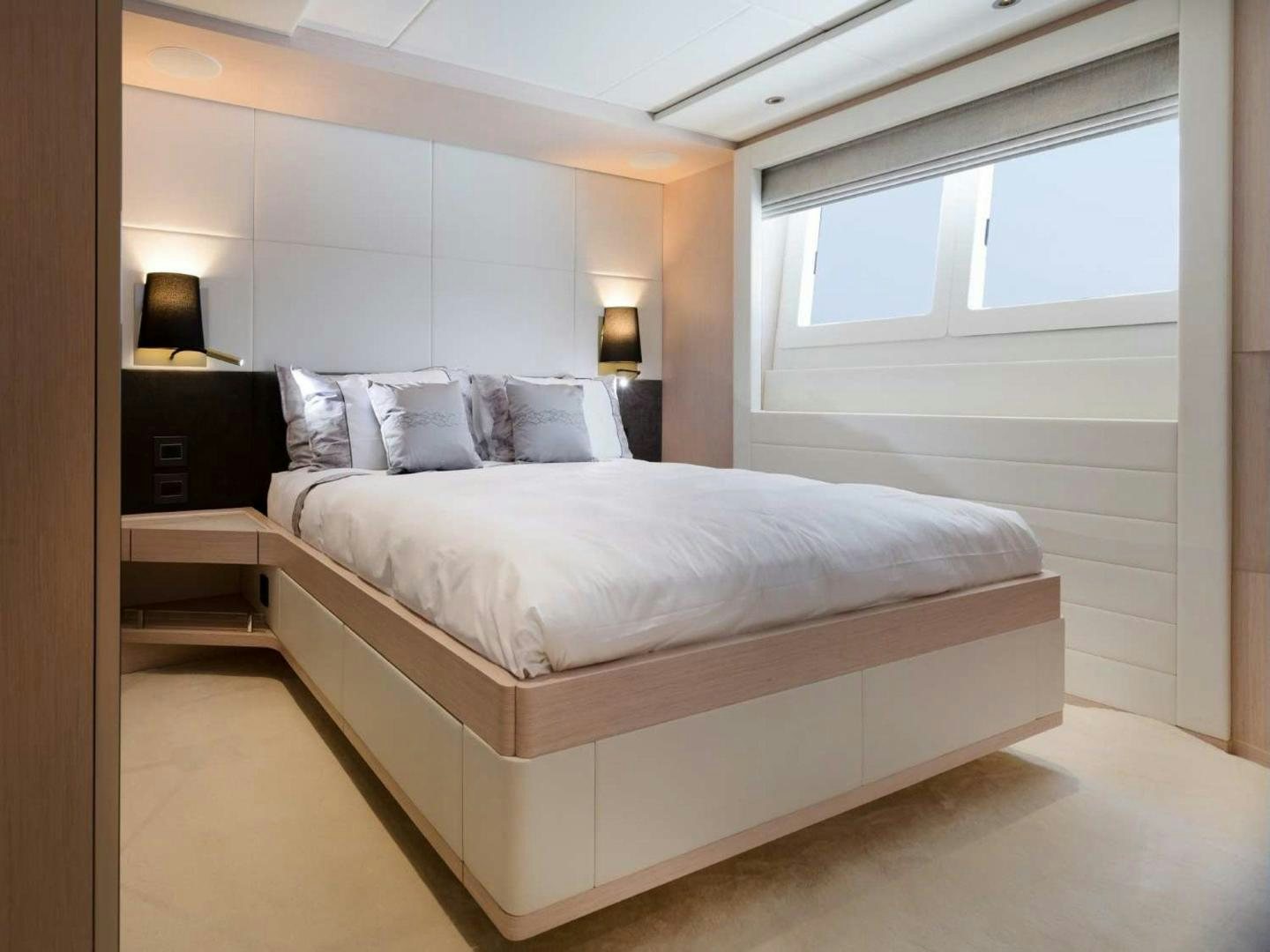 a bedroom with a bed and a window aboard OCEAN VIEW Yacht for Sale