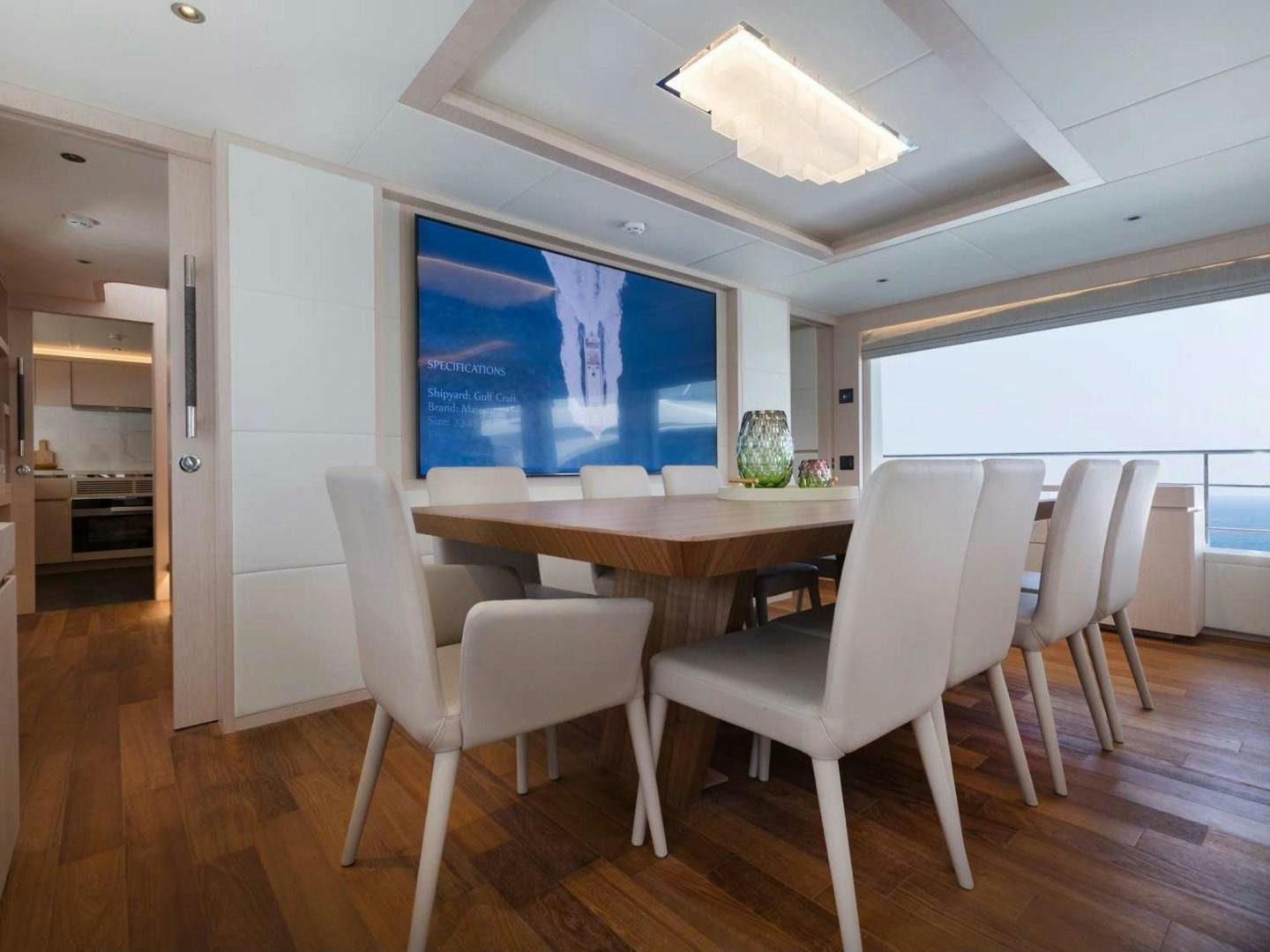 a room with a table and chairs aboard OCEAN VIEW Yacht for Sale