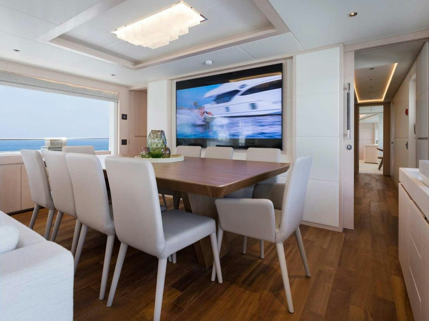 a room with a table and chairs aboard OCEAN VIEW Yacht for Sale