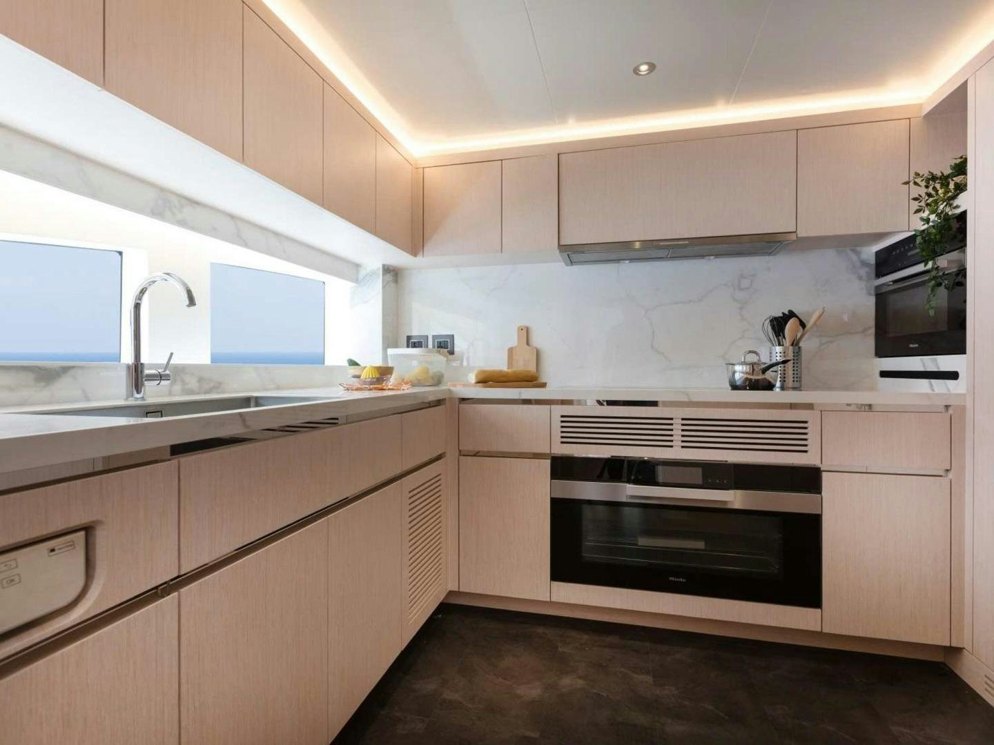 a kitchen with white cabinets aboard OCEAN VIEW Yacht for Sale
