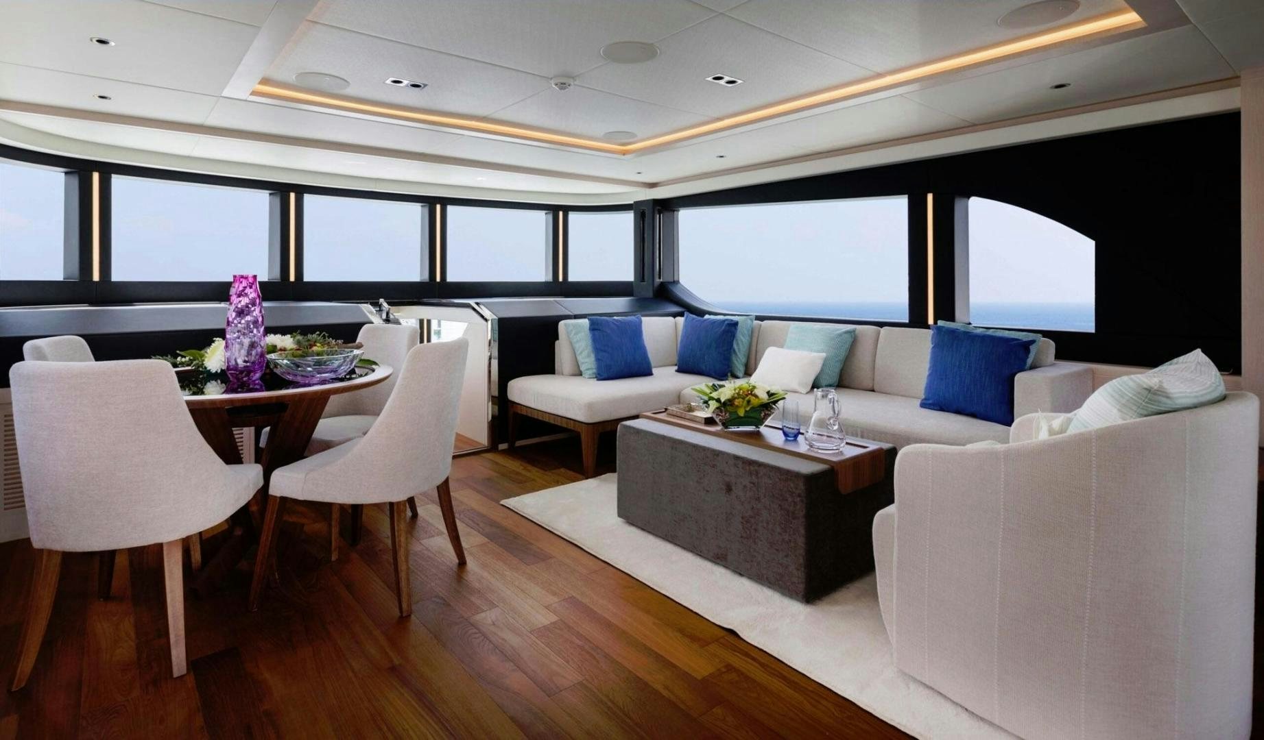 a room with a table and chairs aboard OCEAN VIEW Yacht for Sale