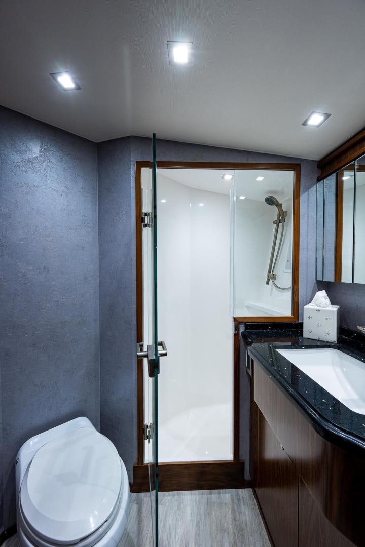a bathroom with a shower and sink aboard KEMOSABE Yacht for Sale