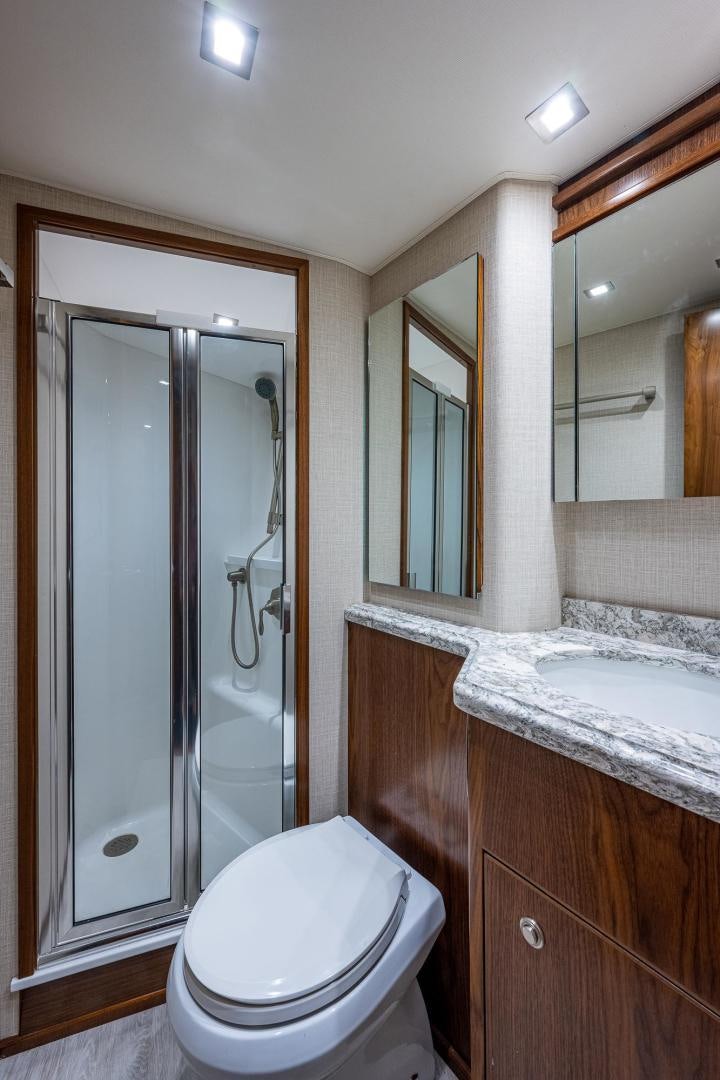 a bathroom with a glass shower door aboard KEMOSABE Yacht for Sale