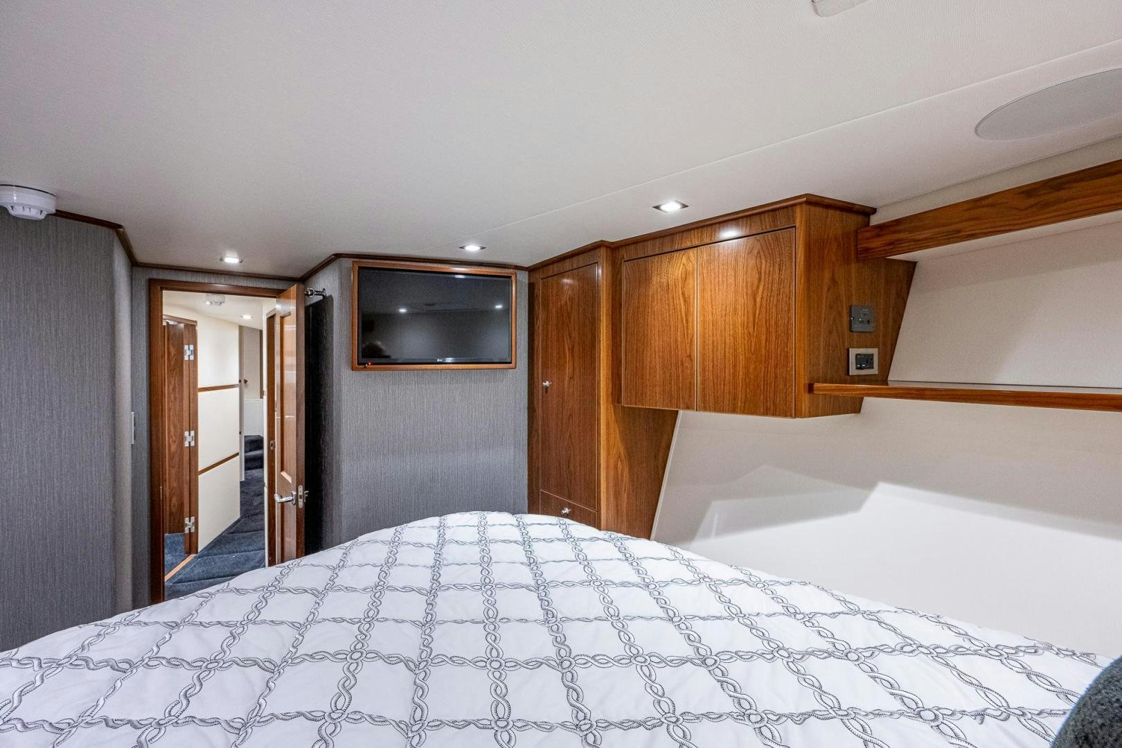 a bedroom with a bed and a television aboard KEMOSABE Yacht for Sale