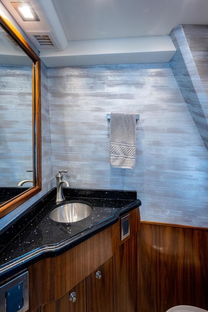 a bathroom with a sink and a mirror aboard KEMOSABE Yacht for Sale
