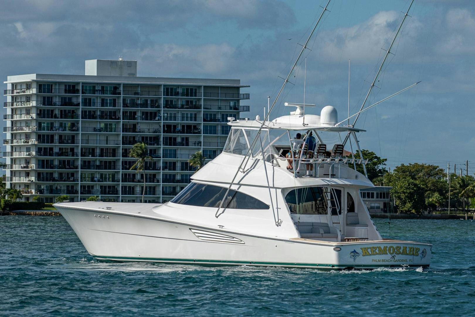 a white boat in front of a building aboard KEMOSABE Yacht for Sale