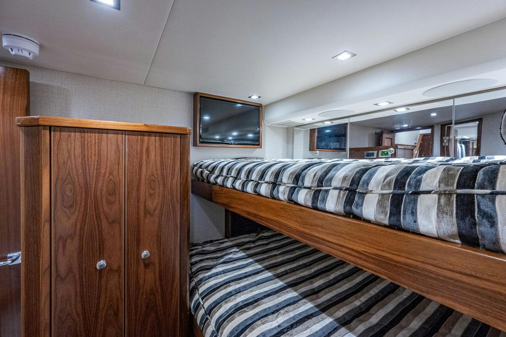 a room with a couch and a television on the wall aboard KEMOSABE Yacht for Sale