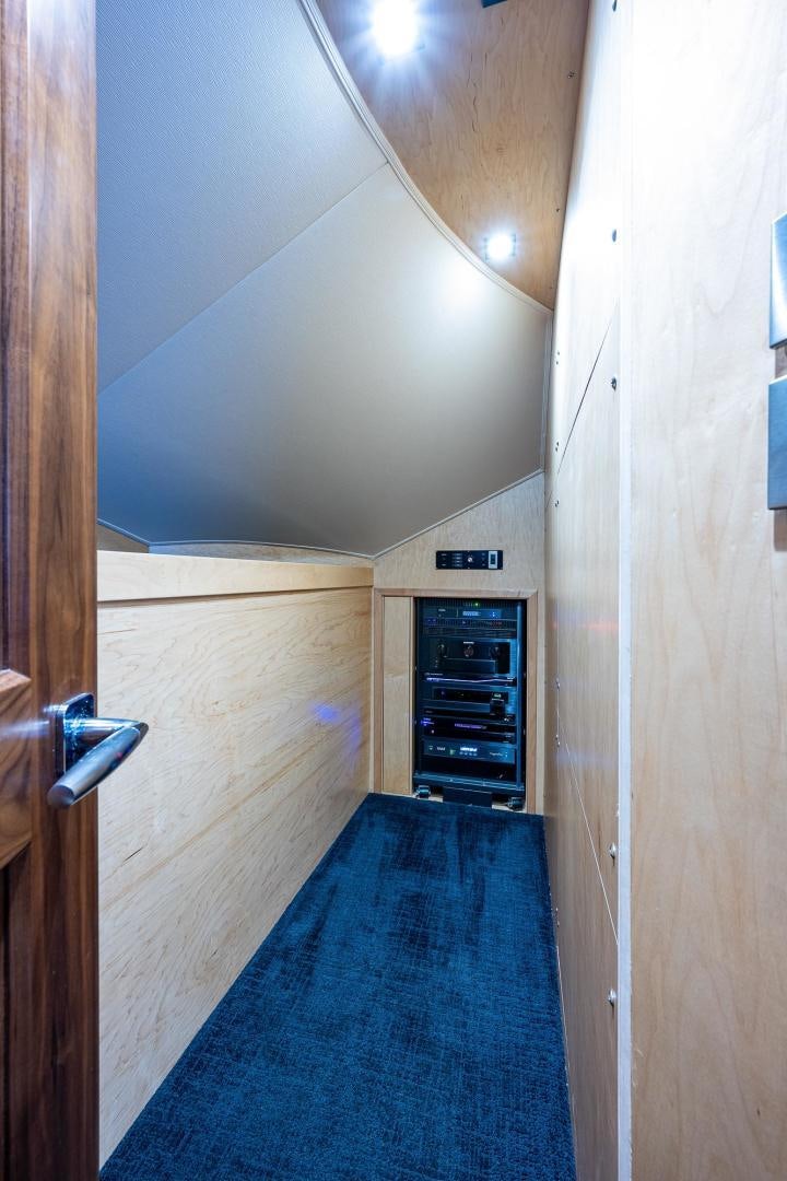 a hallway with a door and a blue carpet aboard KEMOSABE Yacht for Sale