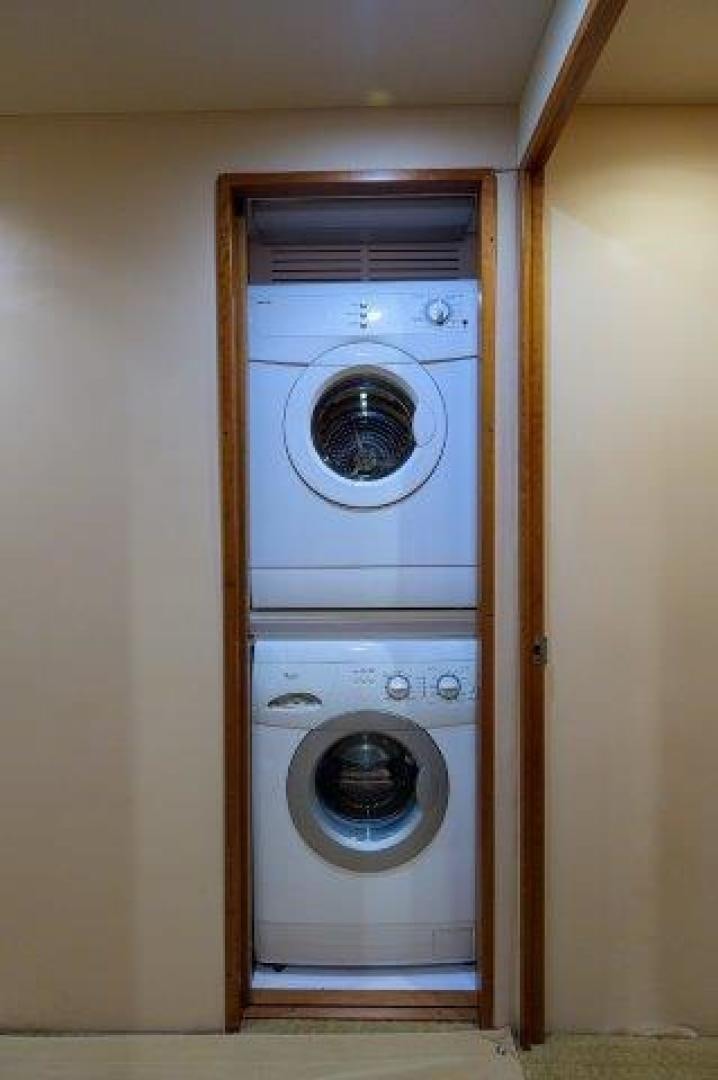 a closet with washer and dryer aboard THERAPY Yacht for Sale