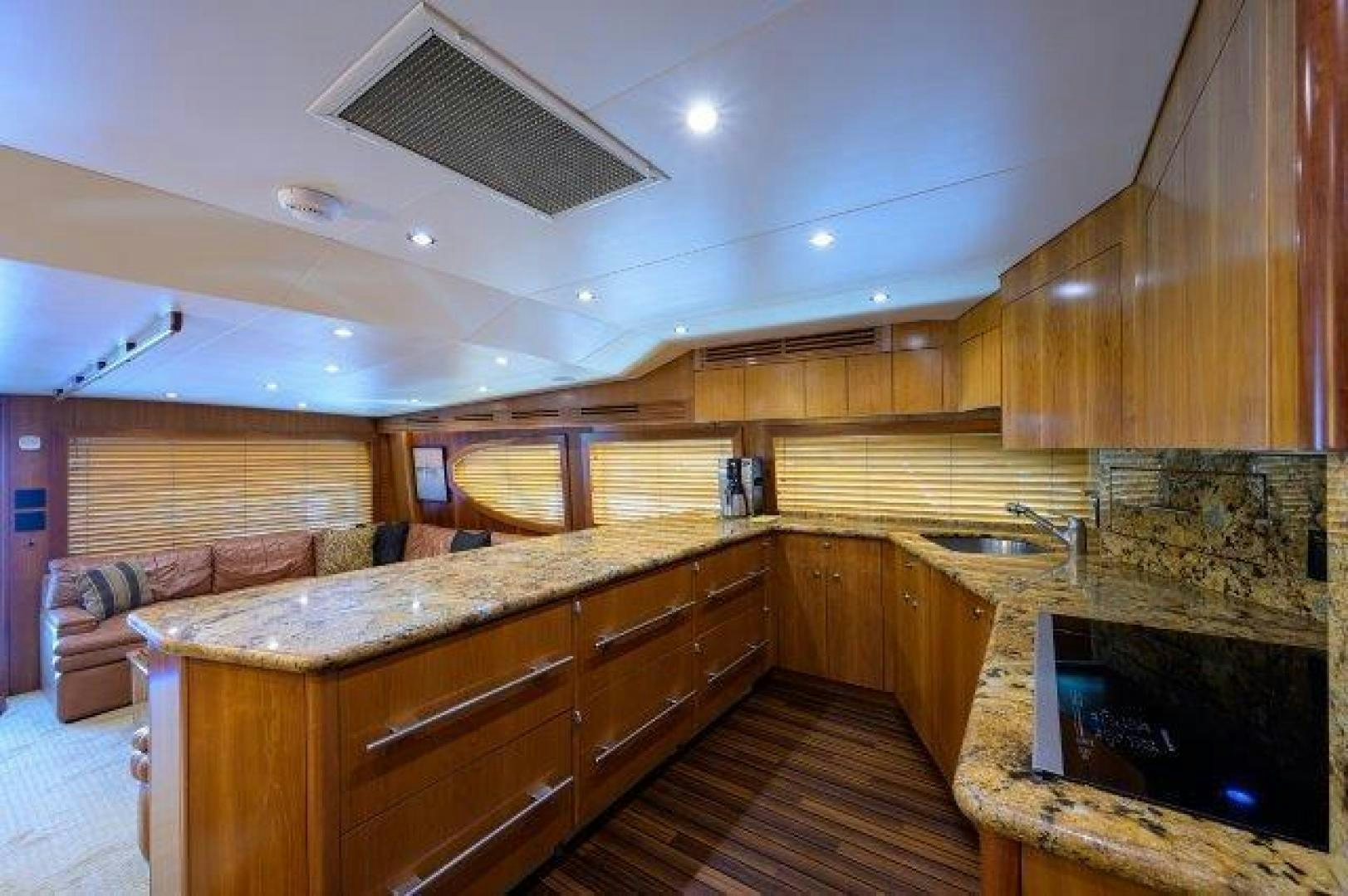 a large kitchen with wooden cabinets aboard THERAPY Yacht for Sale