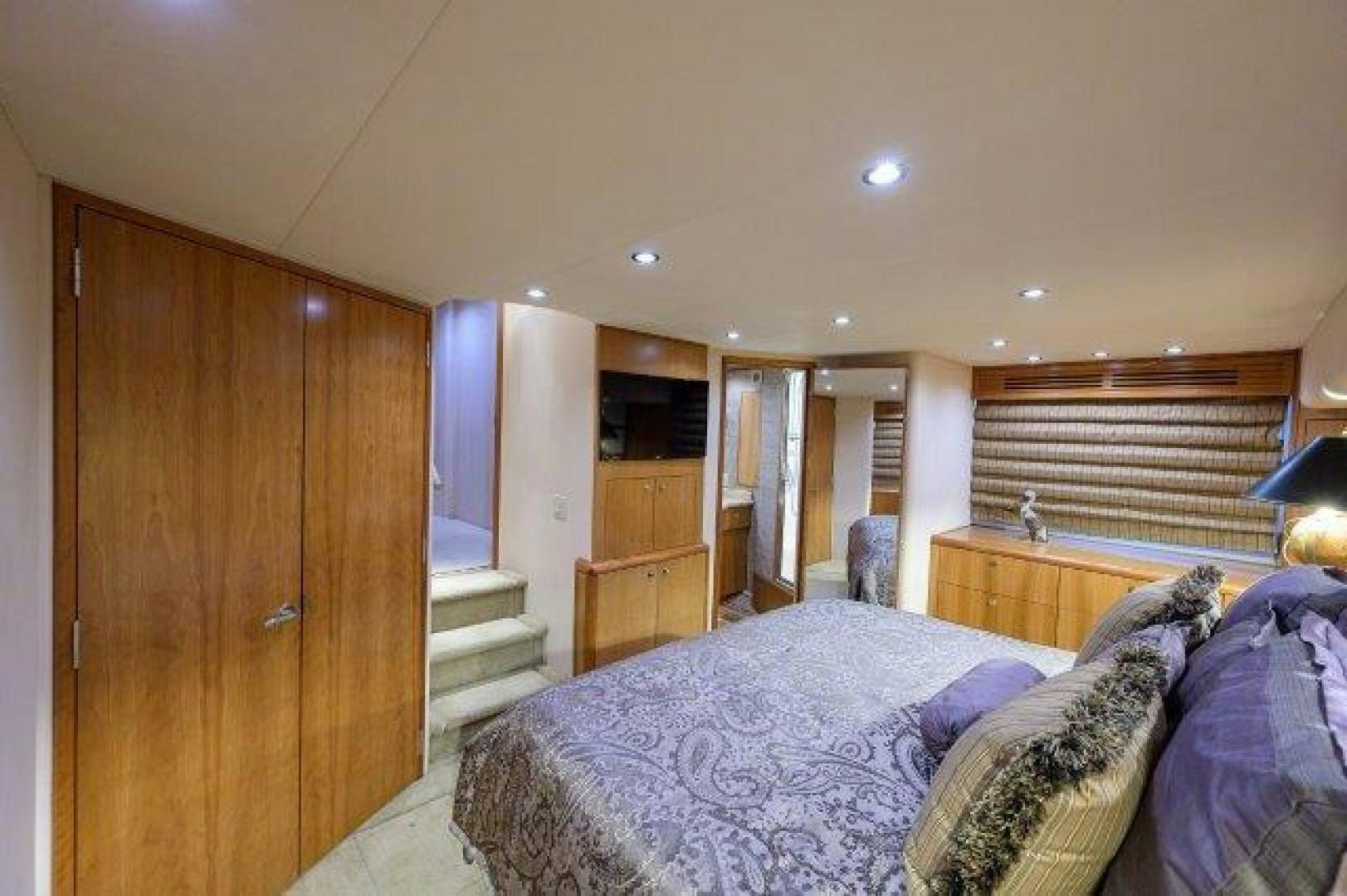 a bedroom with a bed and a closet aboard THERAPY Yacht for Sale
