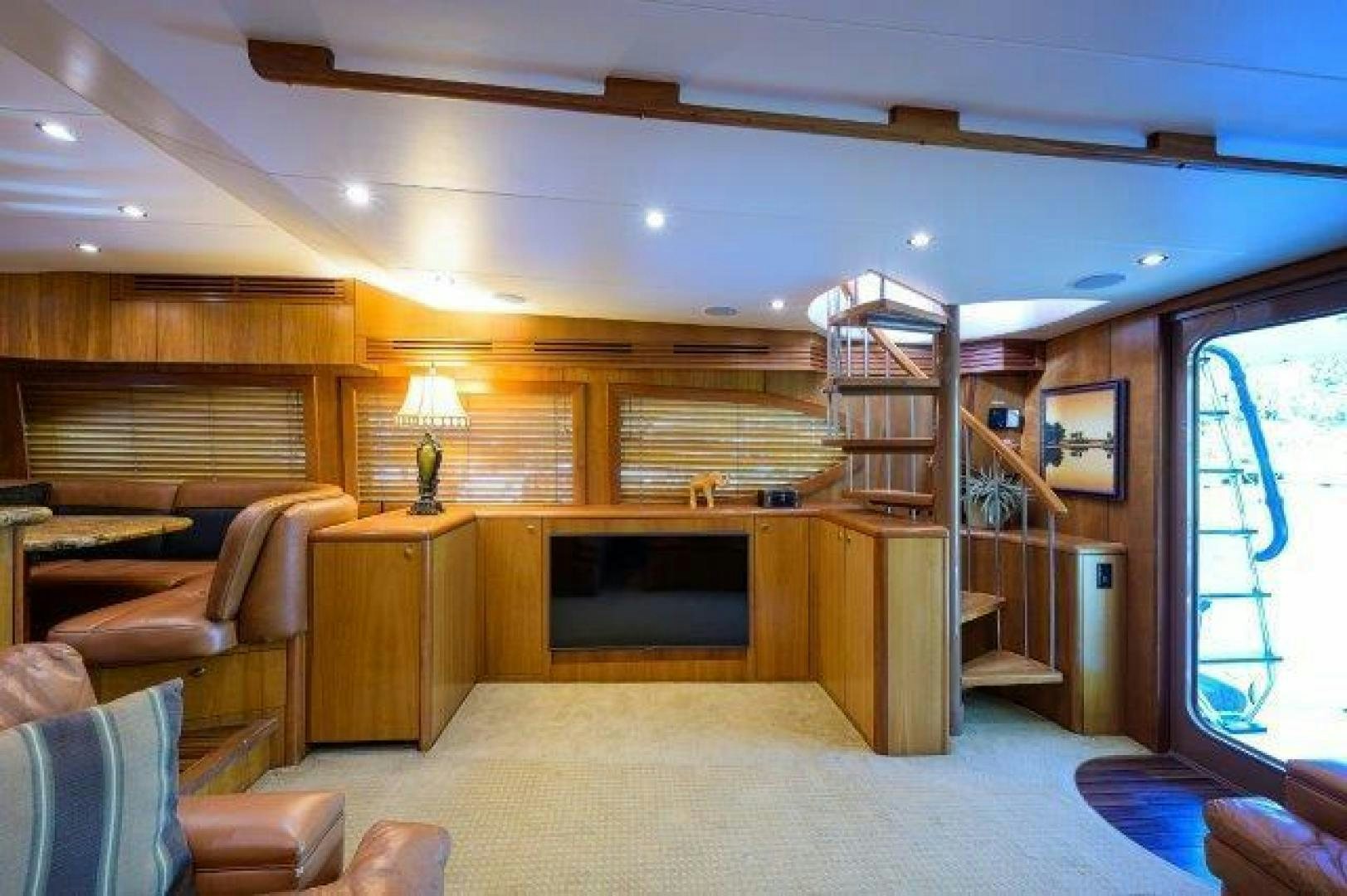a living room with a fireplace aboard THERAPY Yacht for Sale