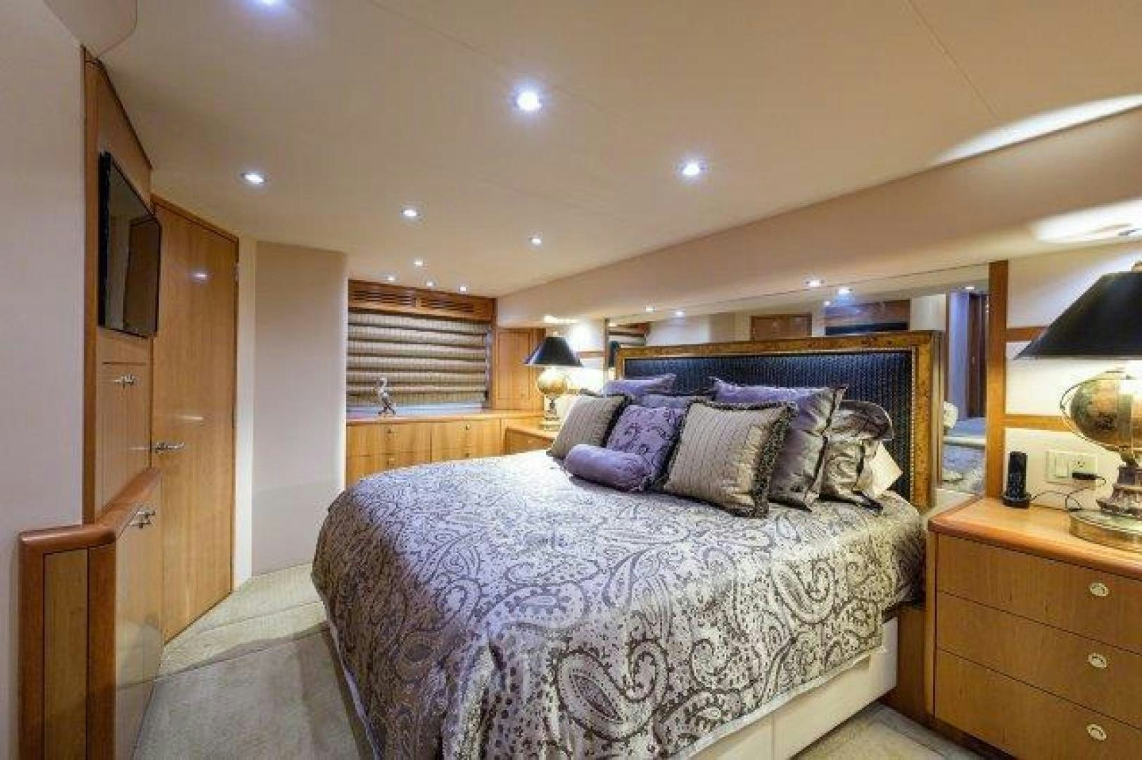a bedroom with a bed and a dresser aboard THERAPY Yacht for Sale