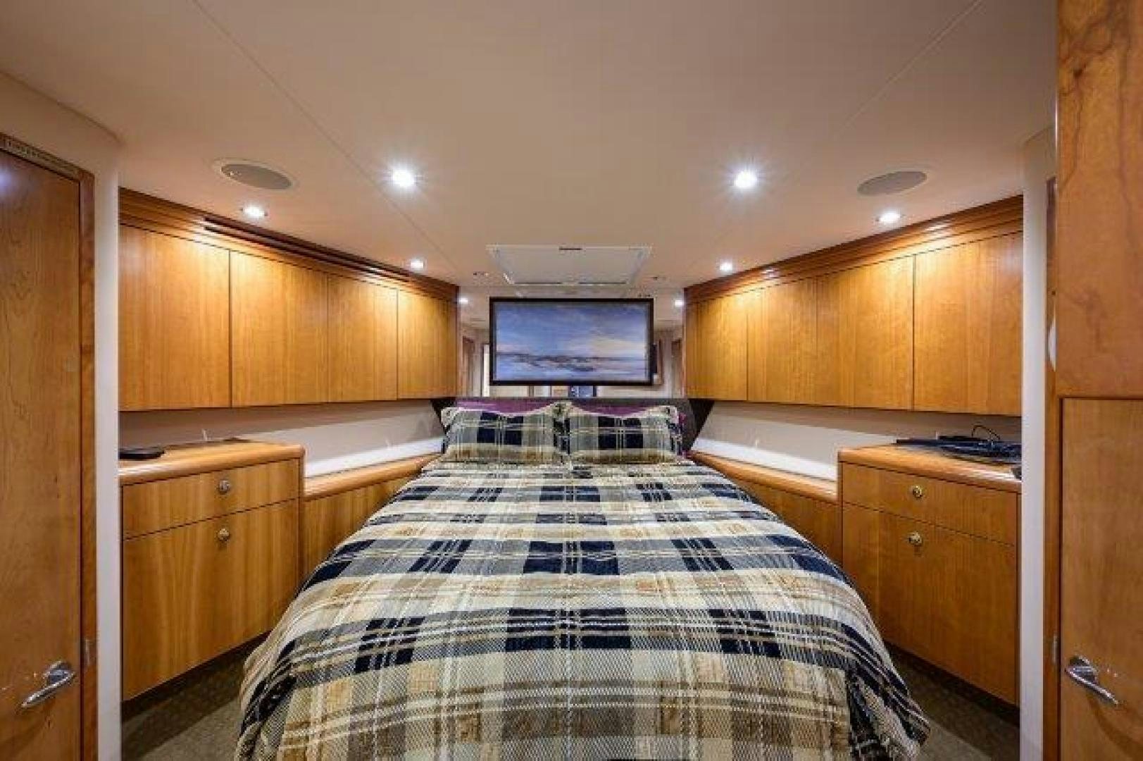 a bedroom with a bed and cabinets aboard THERAPY Yacht for Sale