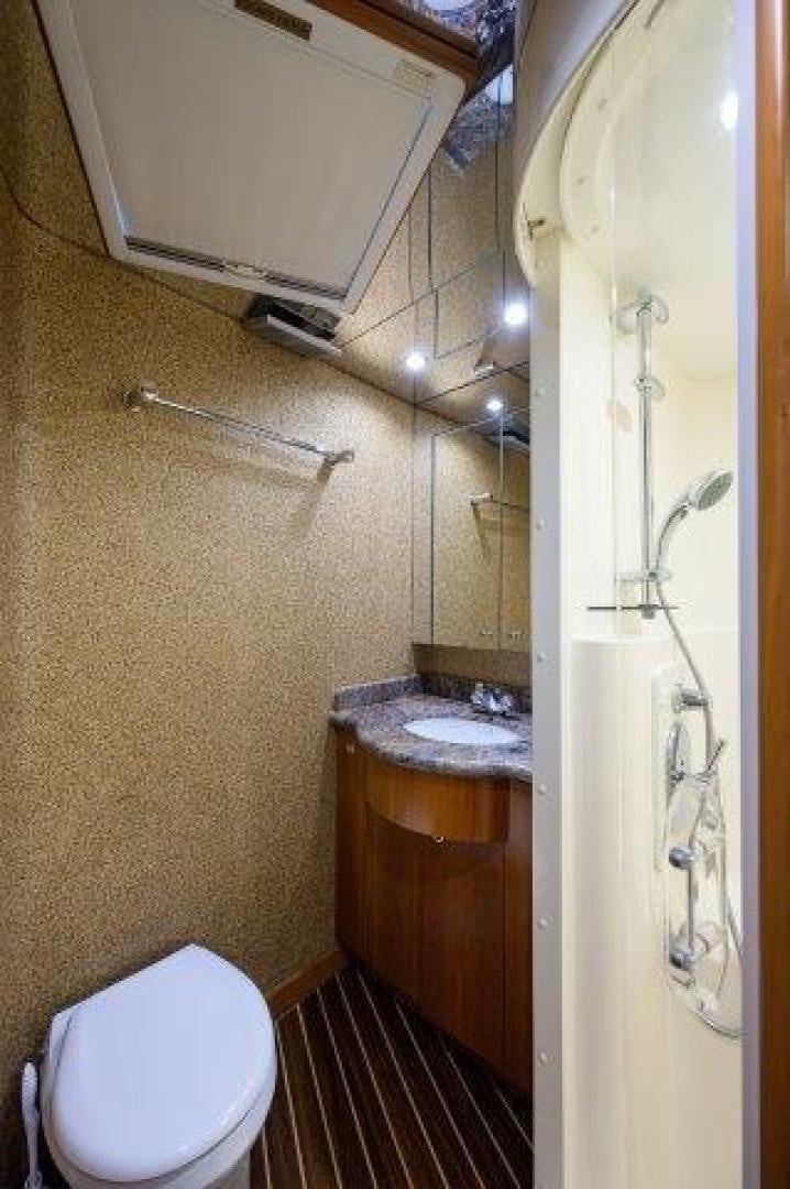 a bathroom with a toilet and sink aboard THERAPY Yacht for Sale