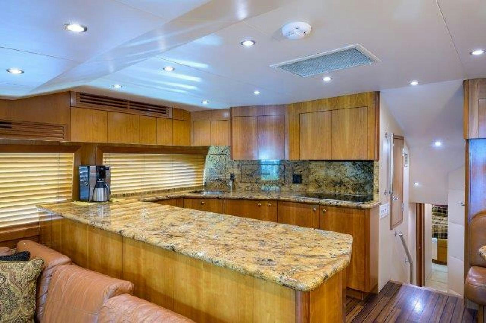 a large kitchen with wooden cabinets aboard THERAPY Yacht for Sale