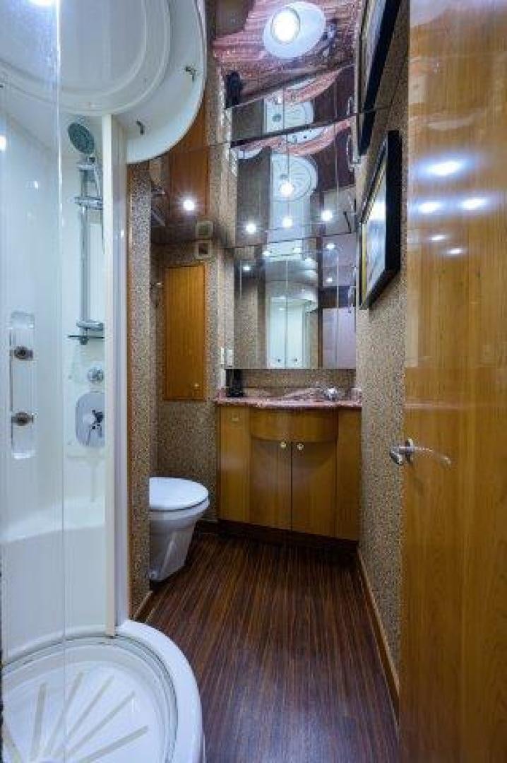 a bathroom with a toilet and a sink aboard THERAPY Yacht for Sale