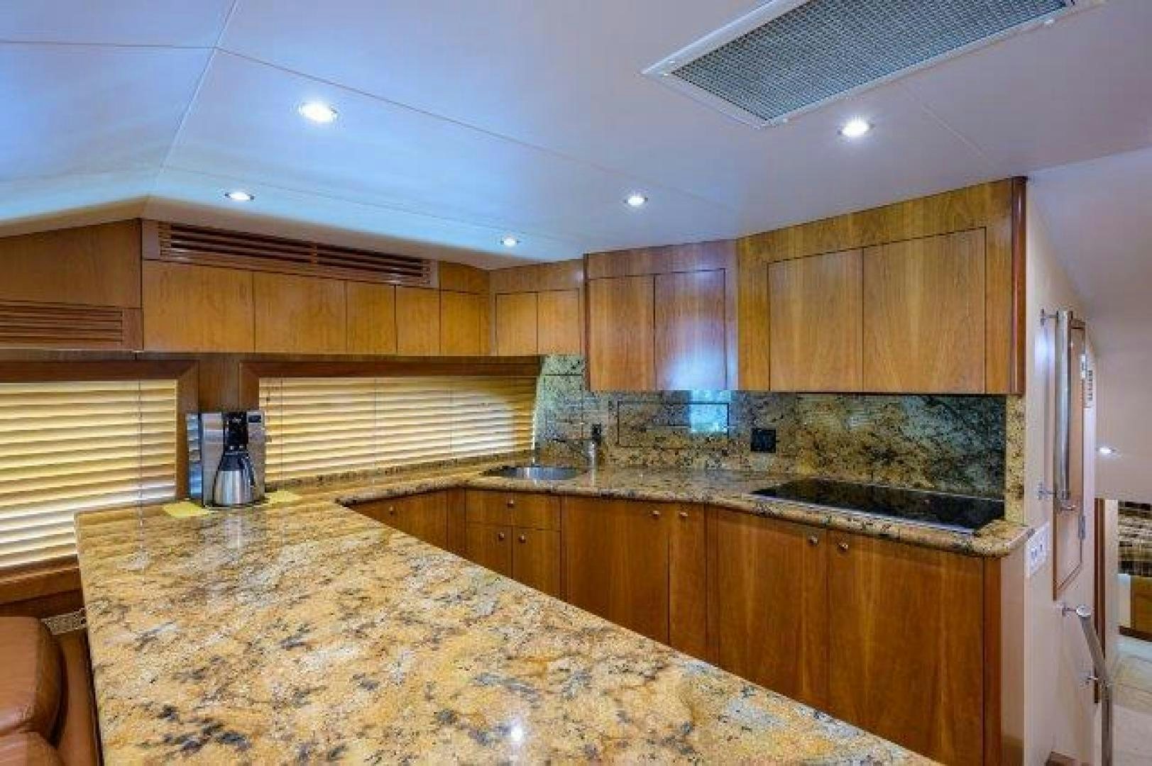 a kitchen with wooden cabinets aboard THERAPY Yacht for Sale