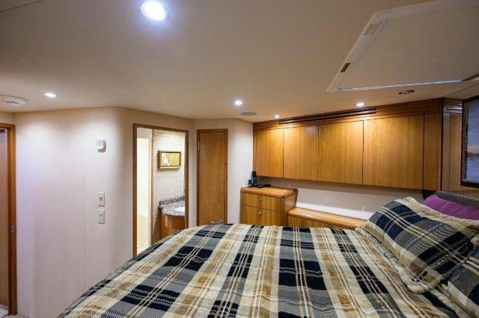 a bedroom with a bed and a desk aboard THERAPY Yacht for Sale