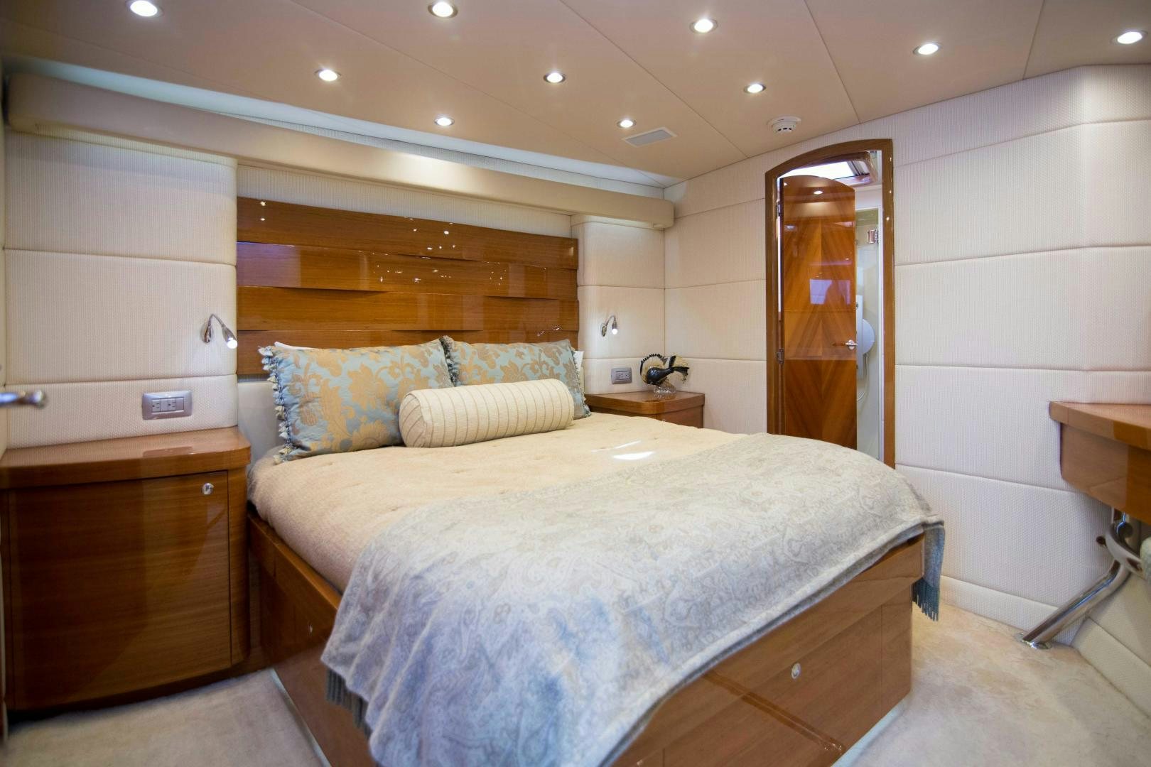 a bedroom with a bed and a dresser aboard PREDATOR Yacht for Sale
