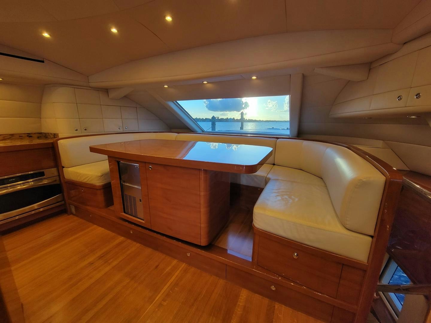 a room with a wood floor and a large window aboard PREDATOR Yacht for Sale