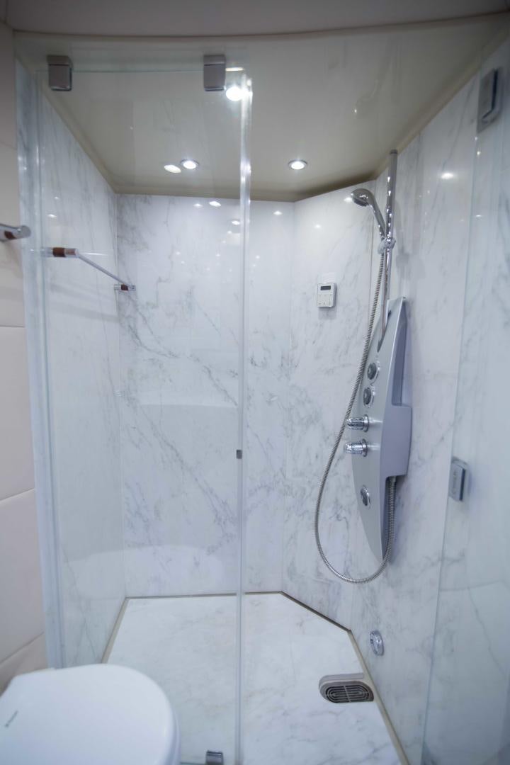a bathroom with a shower aboard PREDATOR Yacht for Sale
