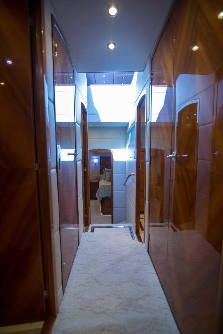a room with a bed and a mirror aboard PREDATOR Yacht for Sale