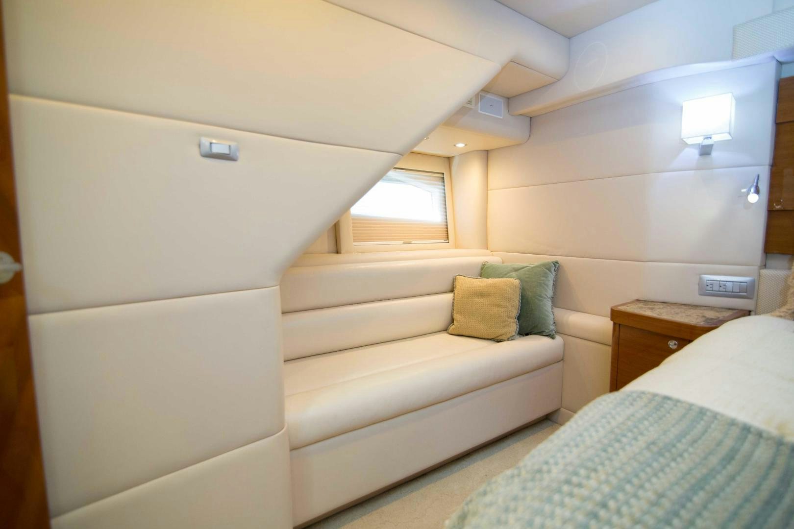 a bed and a couch in a room aboard PREDATOR Yacht for Sale