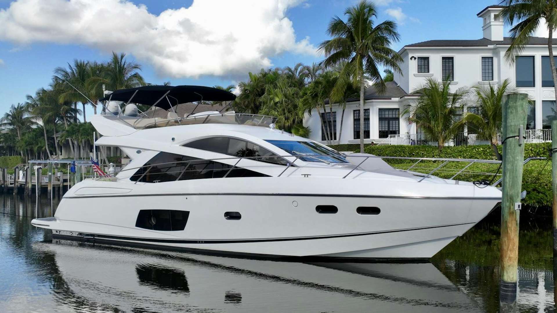 a white boat on a body of water aboard UTOPIA Yacht for Sale