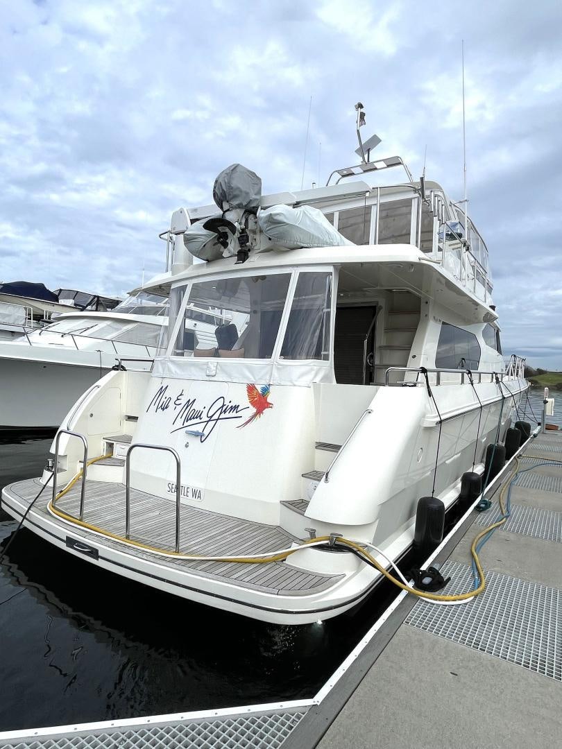 a white boat on a dock aboard MIA & MAUI JIM Yacht for Sale