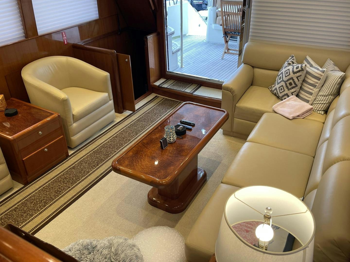 a living room with a glass coffee table and a view of the water aboard MIA & MAUI JIM Yacht for Sale