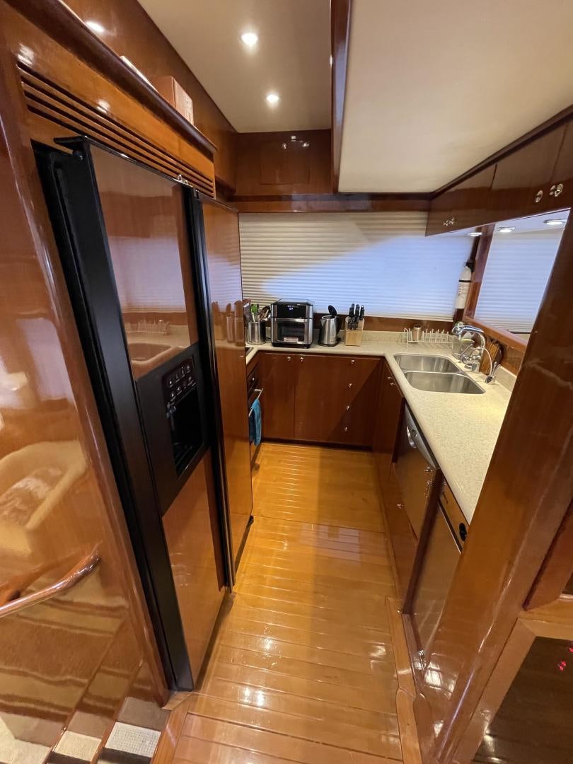 a kitchen with a stainless steel refrigerator aboard MIA & MAUI JIM Yacht for Sale