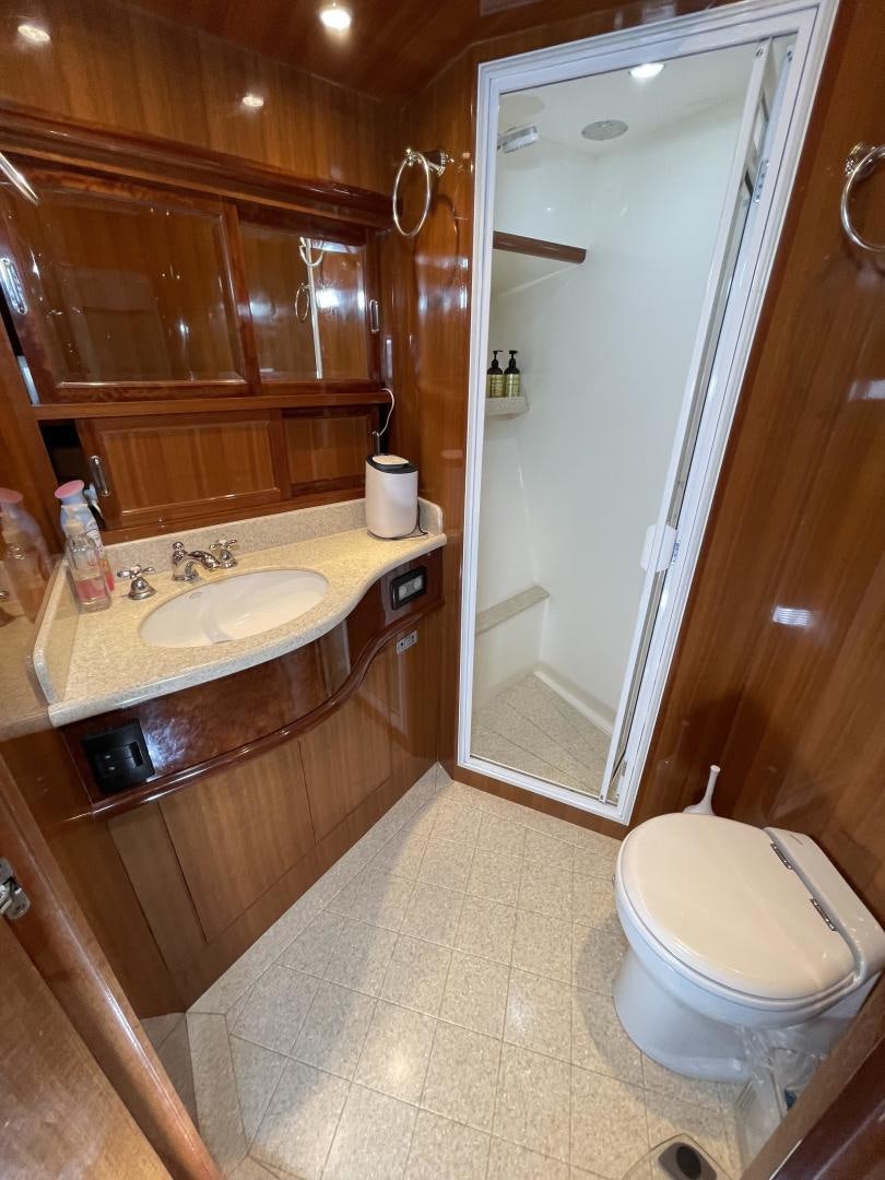 a bathroom with wooden cabinets aboard MIA & MAUI JIM Yacht for Sale