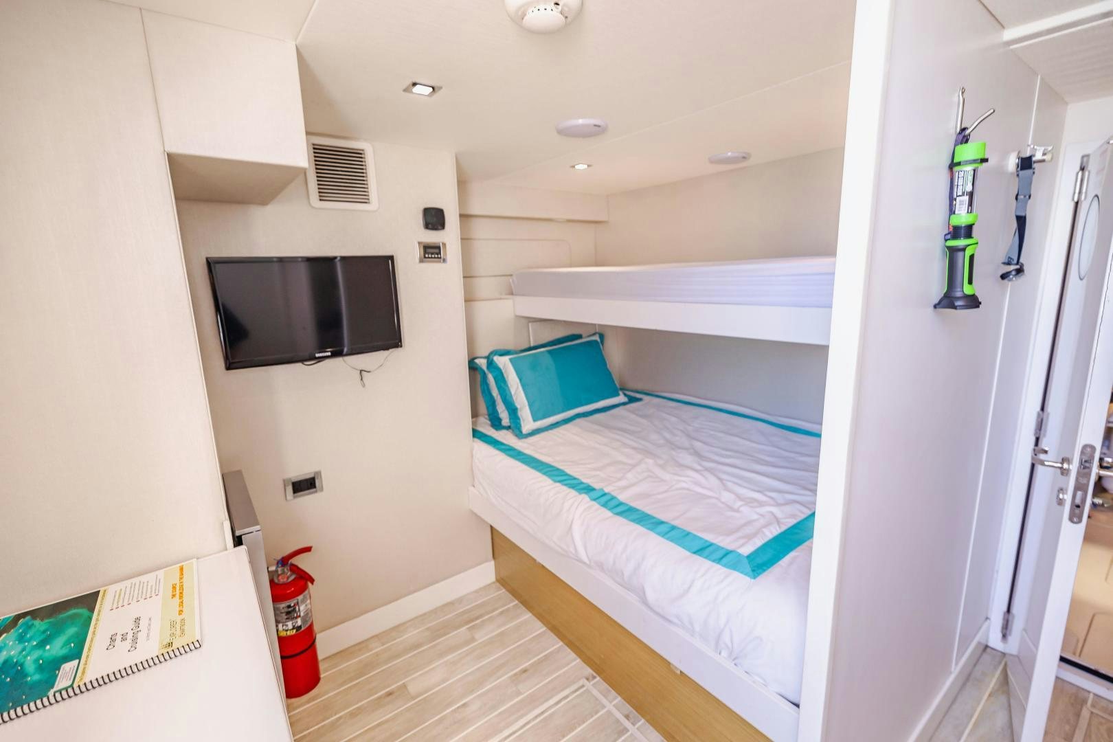 a room with a bed and a television aboard BELLA SKY Yacht for Sale