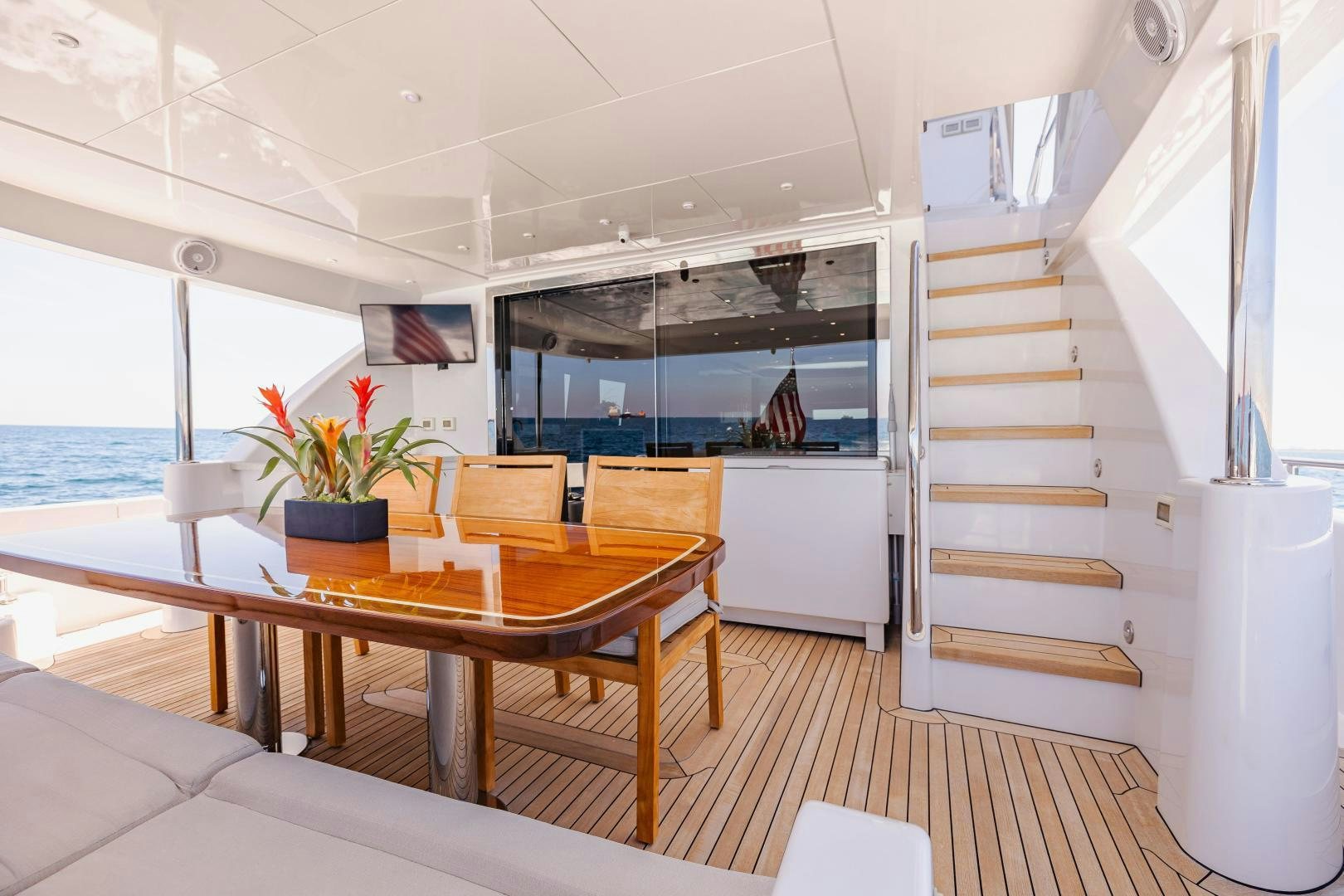 a room with a table and chairs aboard BELLA SKY Yacht for Sale
