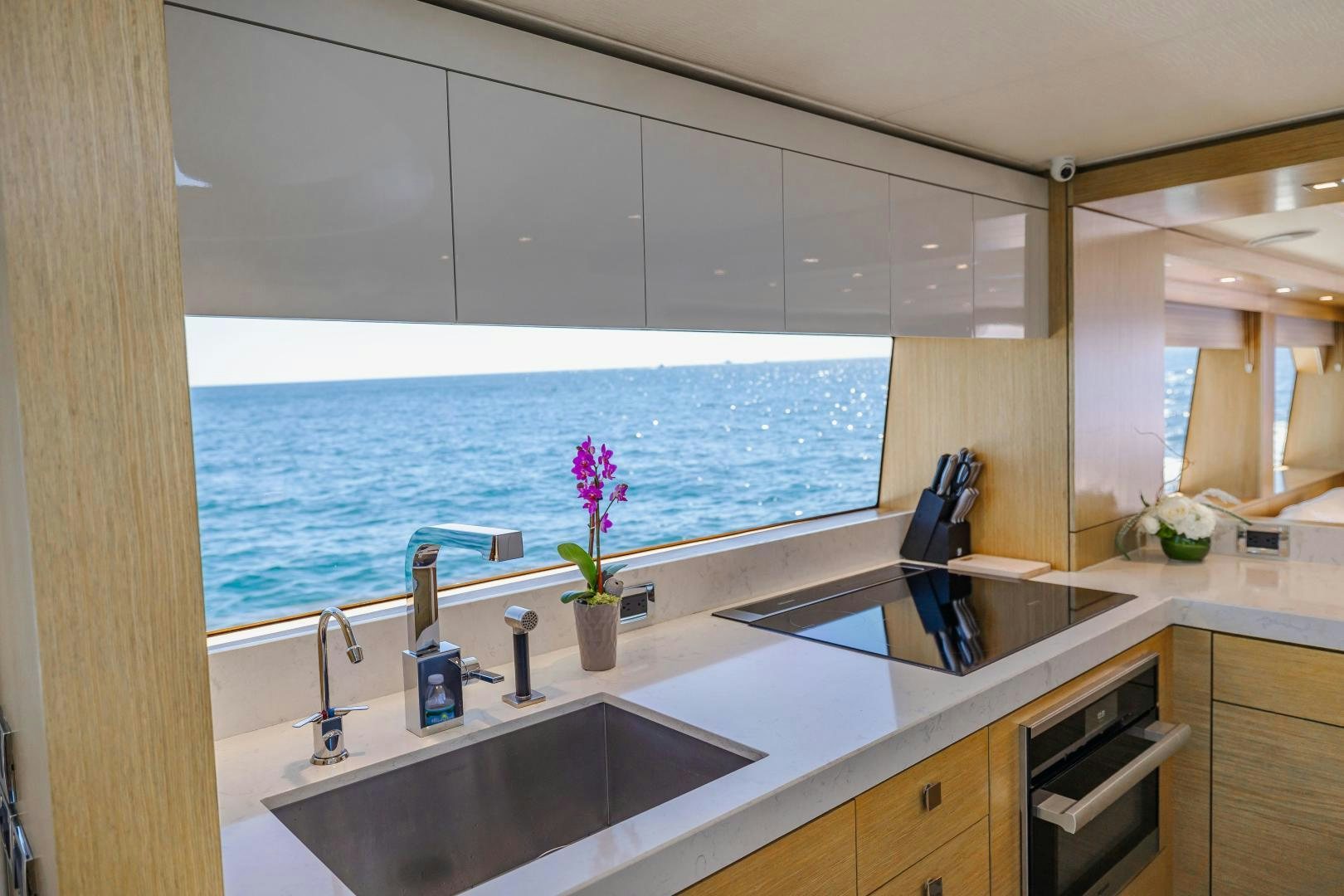 a bathroom with a sink and a window aboard BELLA SKY Yacht for Sale