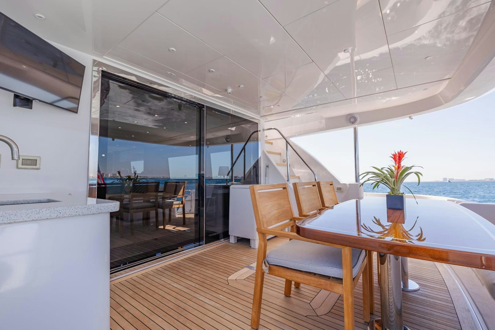 a room with a table and chairs aboard BELLA SKY Yacht for Sale