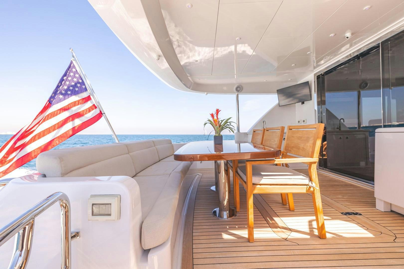 a room with a table and chairs aboard BELLA SKY Yacht for Sale