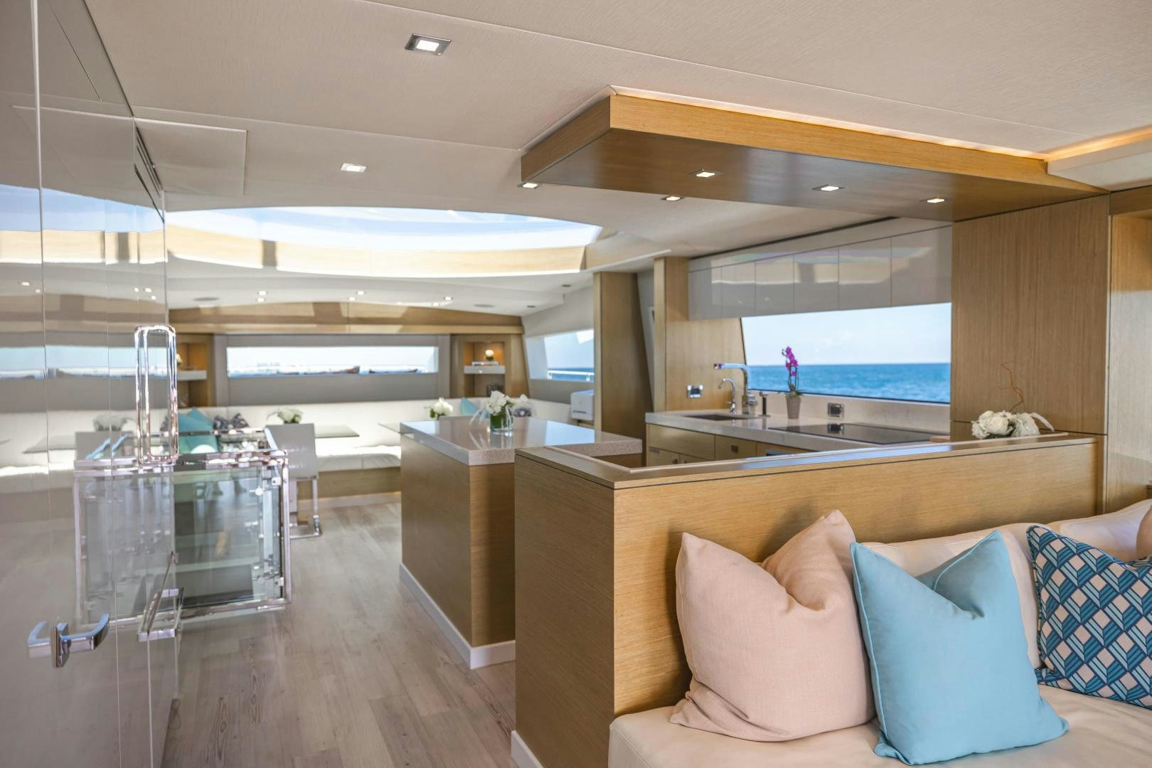 a modern living room with a large glass window aboard BELLA SKY Yacht for Sale