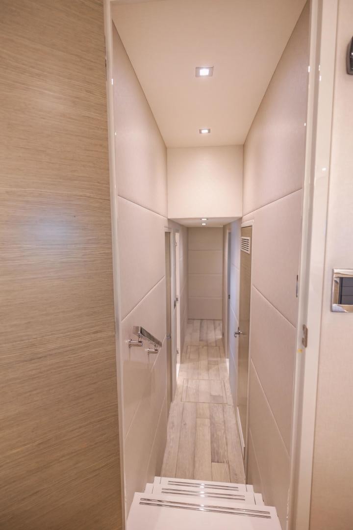 a hallway with a door and a mirror aboard BELLA SKY Yacht for Sale