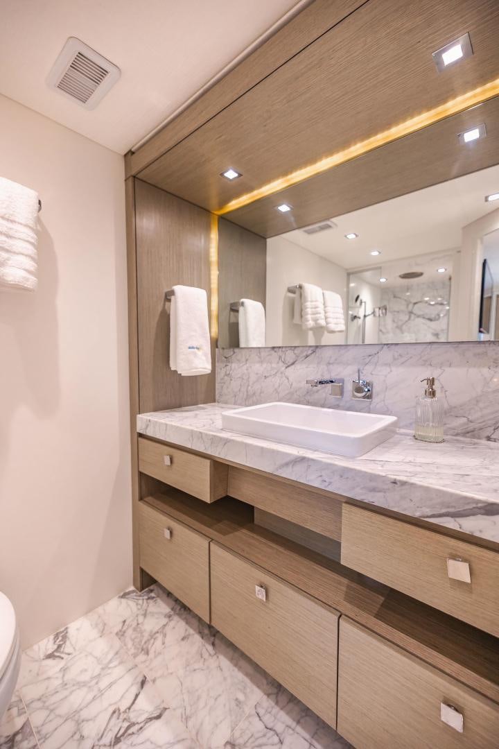 a bathroom with a large mirror aboard BELLA SKY Yacht for Sale