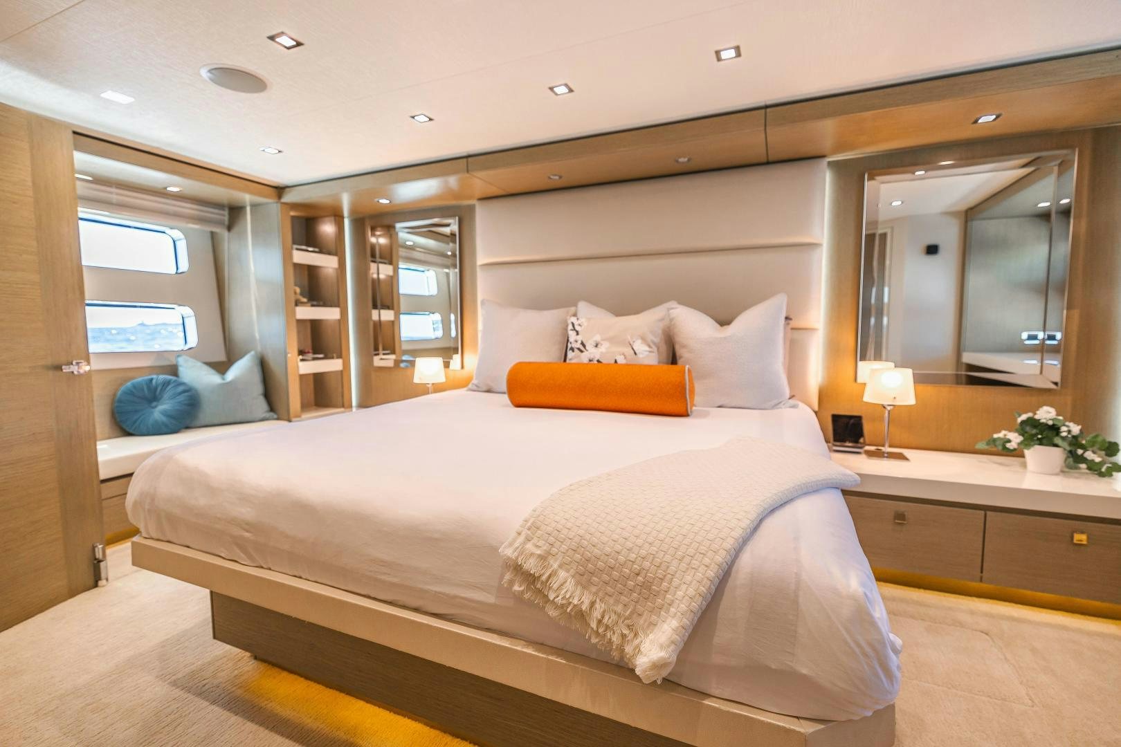 a bed with a white comforter aboard BELLA SKY Yacht for Sale