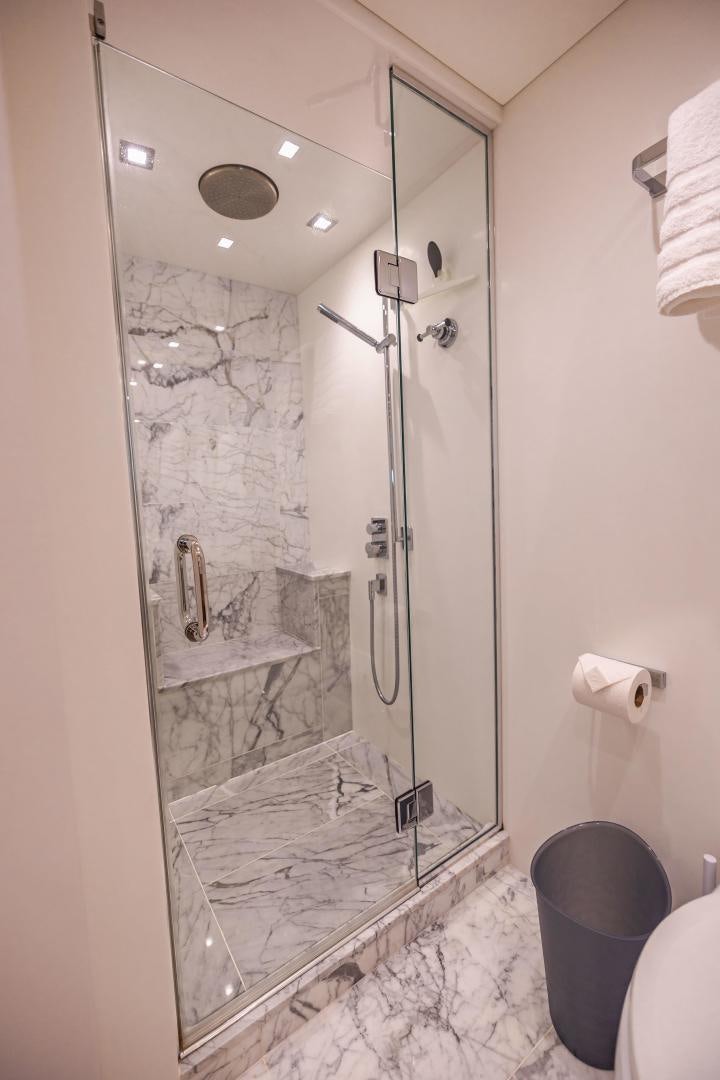 a bathroom with a glass shower aboard BELLA SKY Yacht for Sale