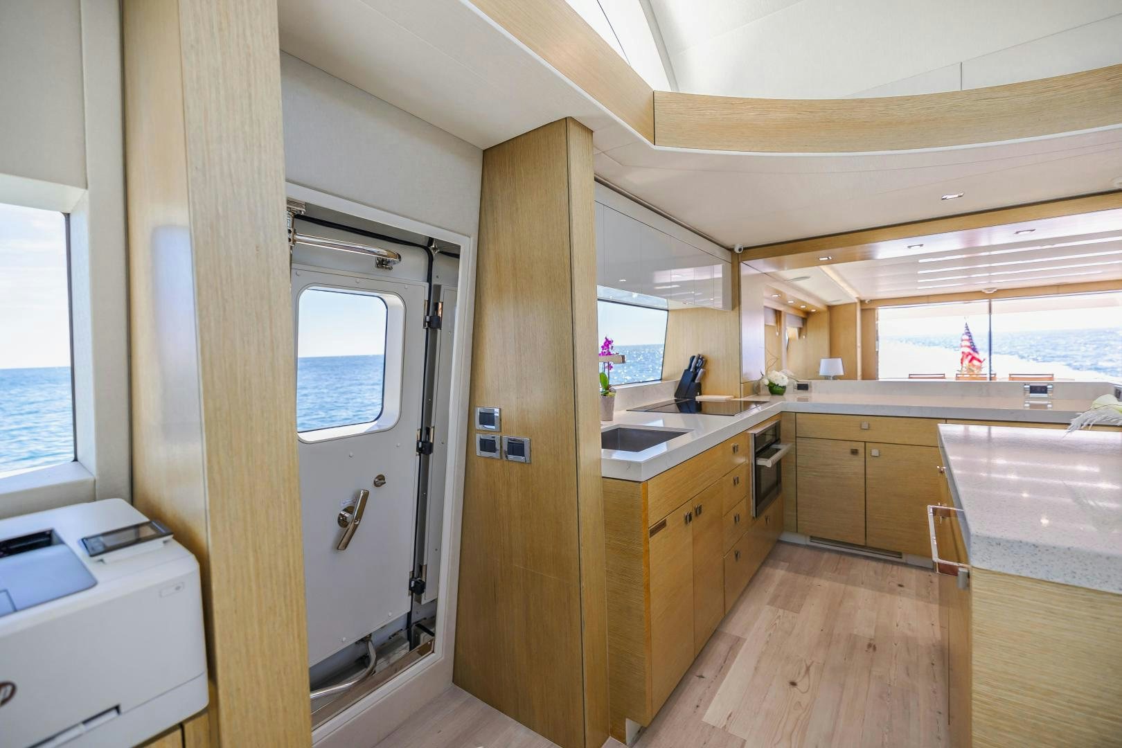 a kitchen with wooden cabinets aboard BELLA SKY Yacht for Sale